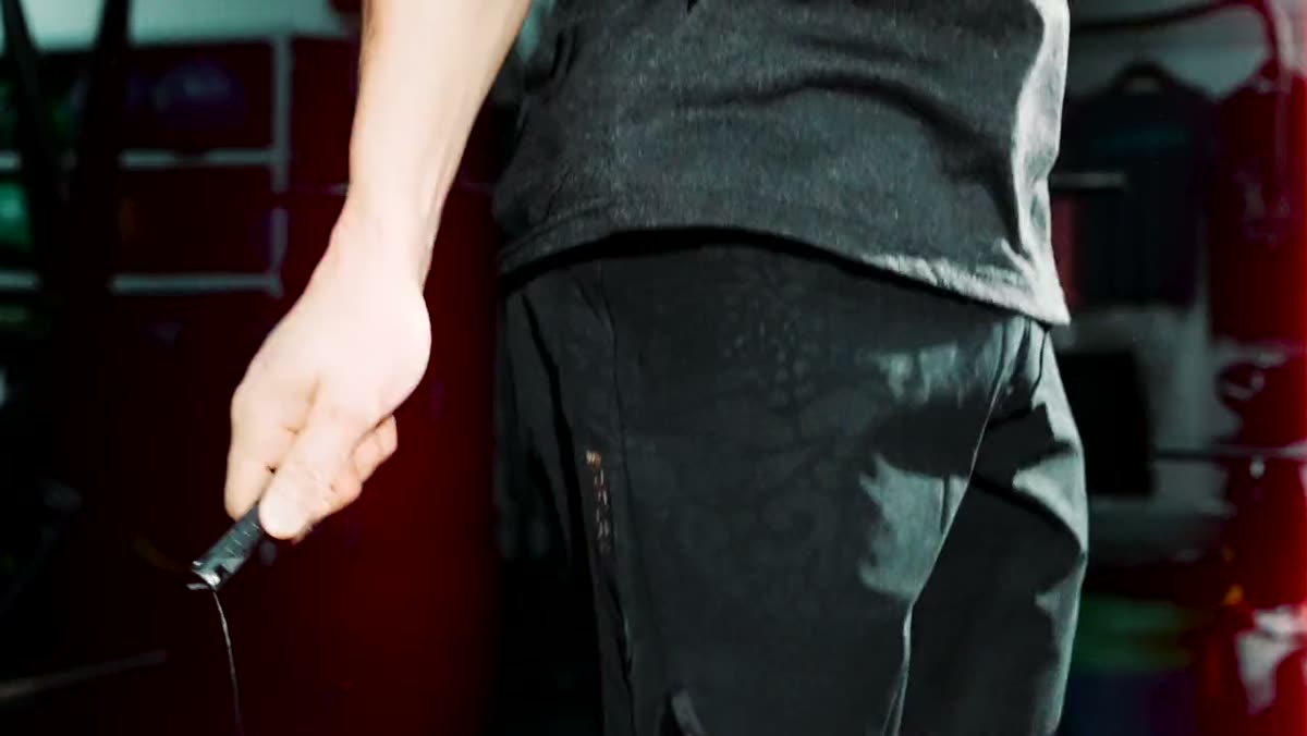 A skipping rope held in a member's hand.