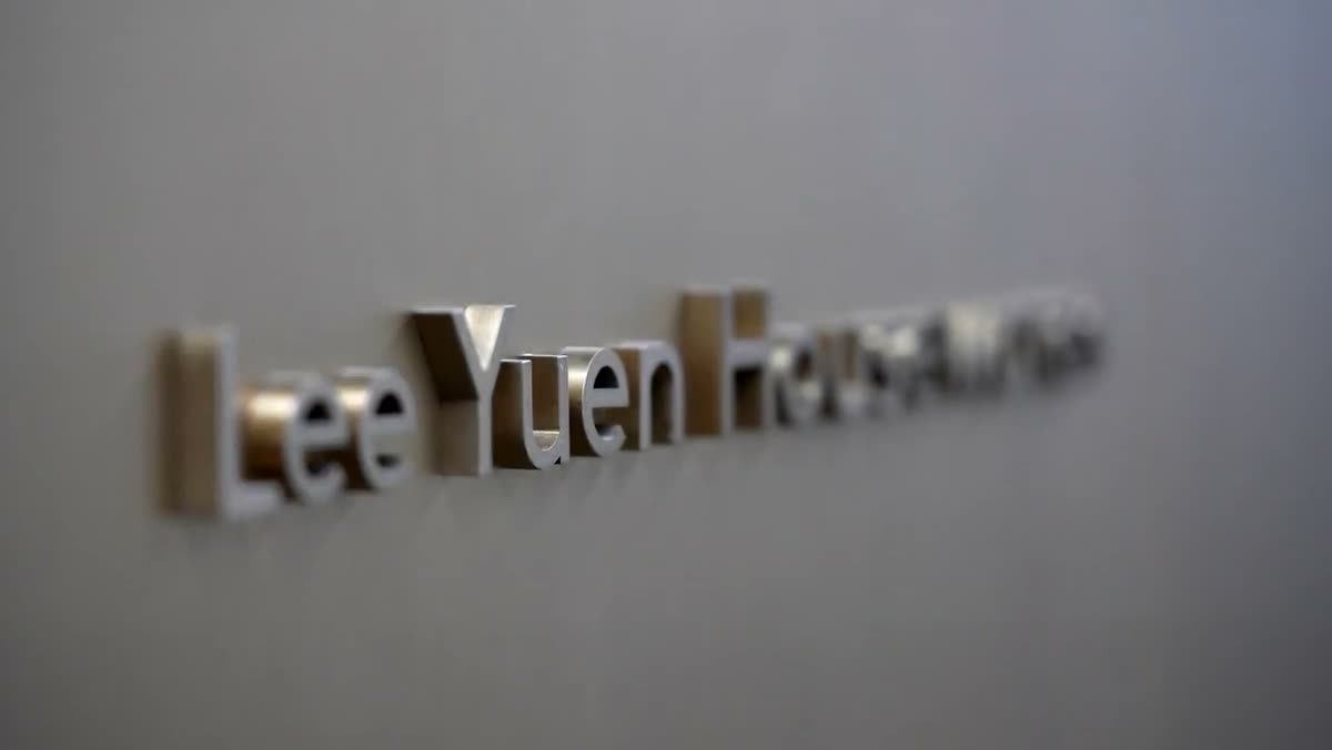 Brushed metal Lee Yuen Houseware lettering on a wall.