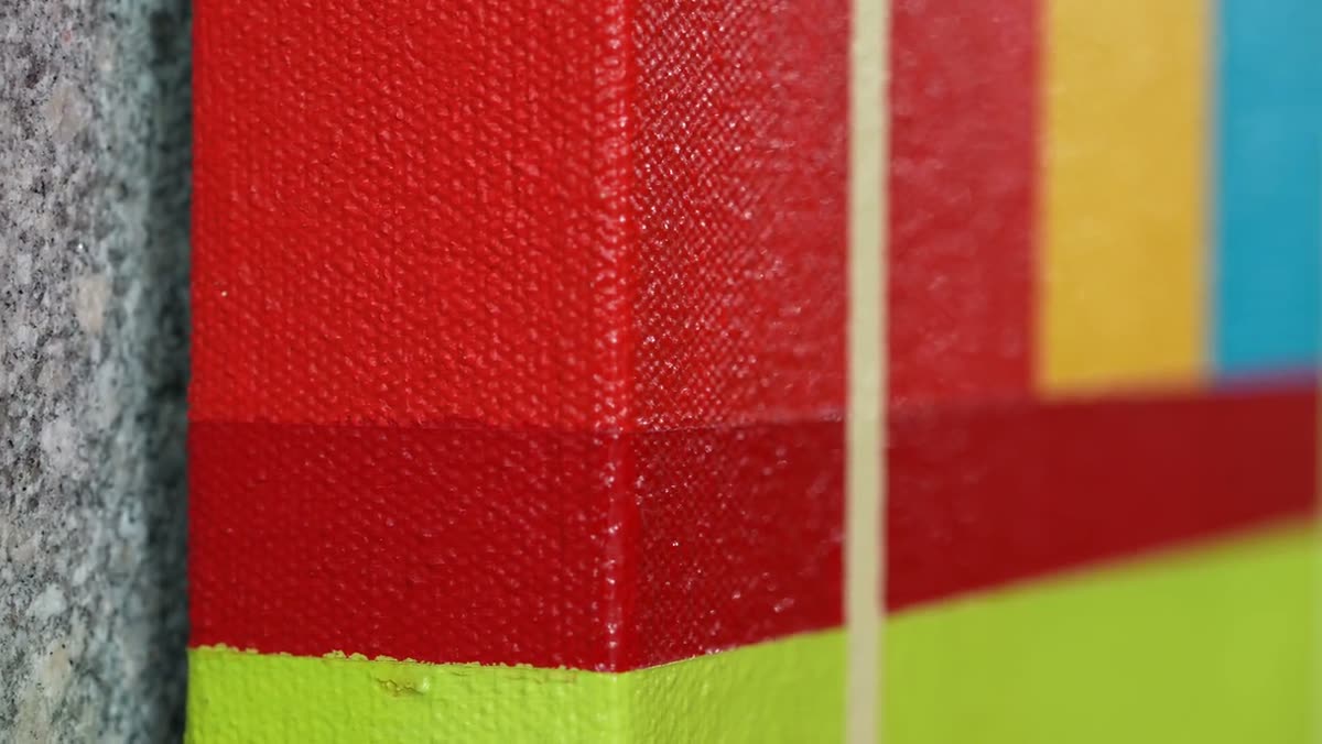 An extreme close-up of the crisp edge between two blocks of colour.