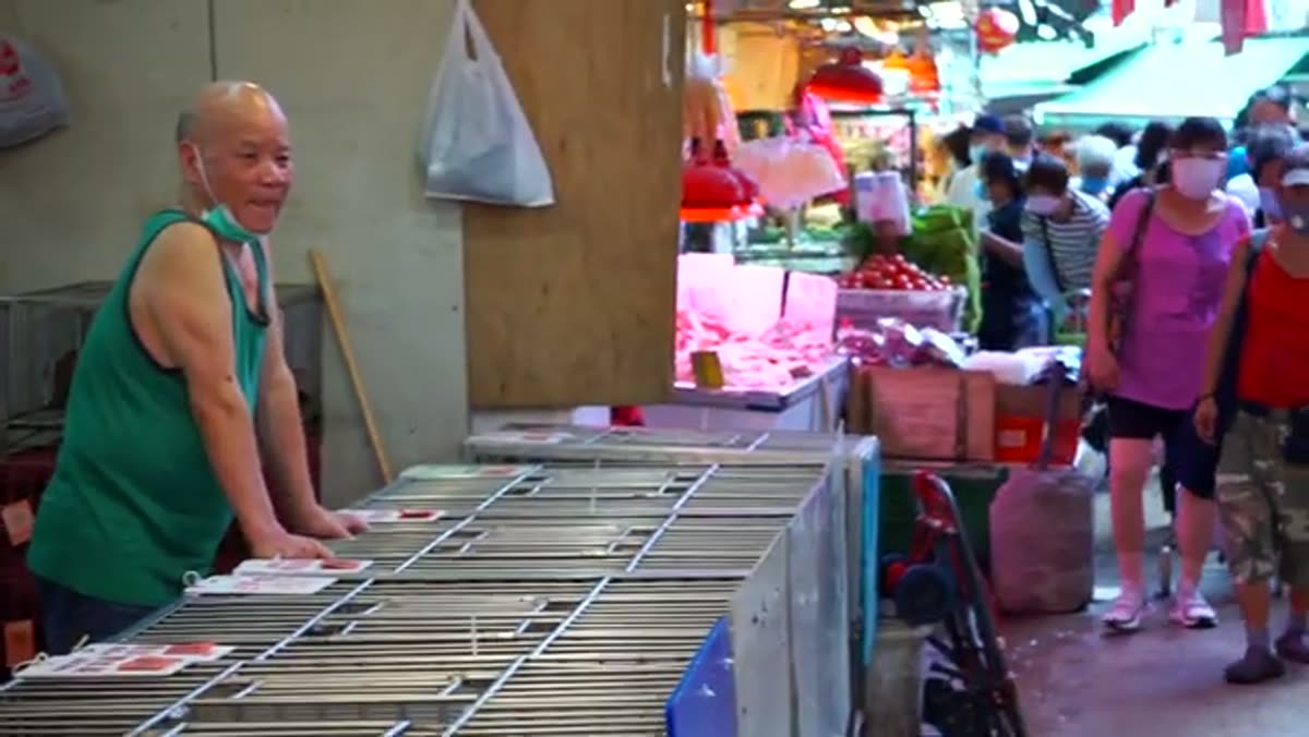 A wet-market stall, and the man working it.