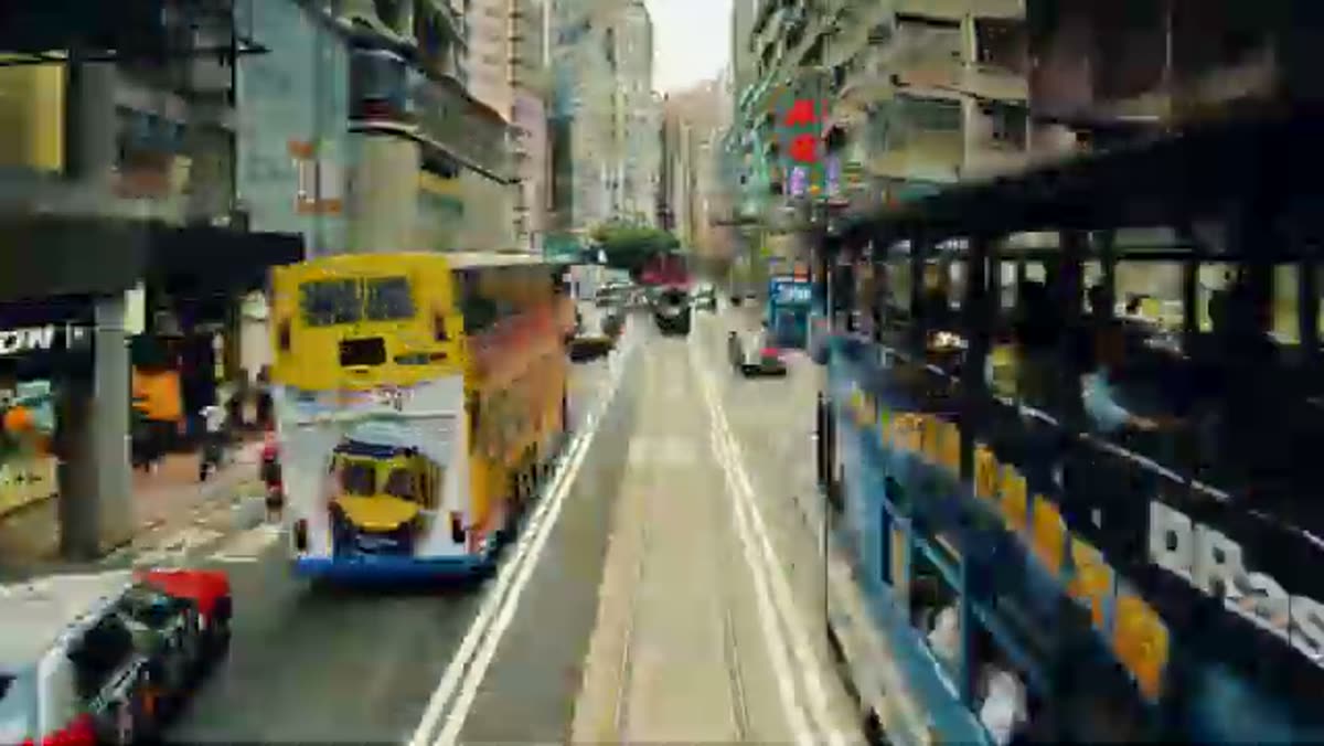 Trams and double-deckers, shot from the deck of one.