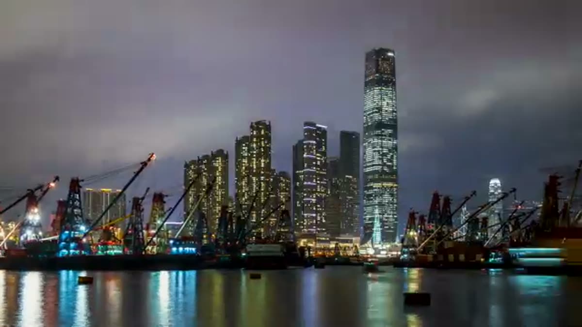 Kowloon at night, cranes still working the waterfront.