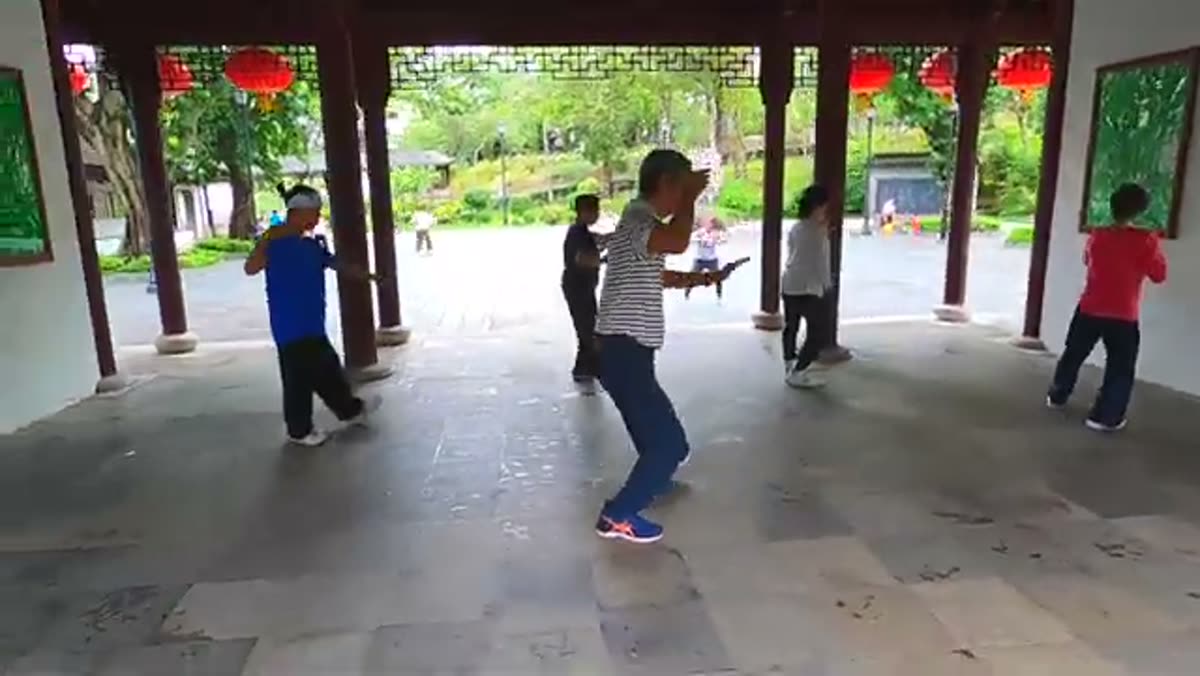 Morning exercise under a park pavilion.