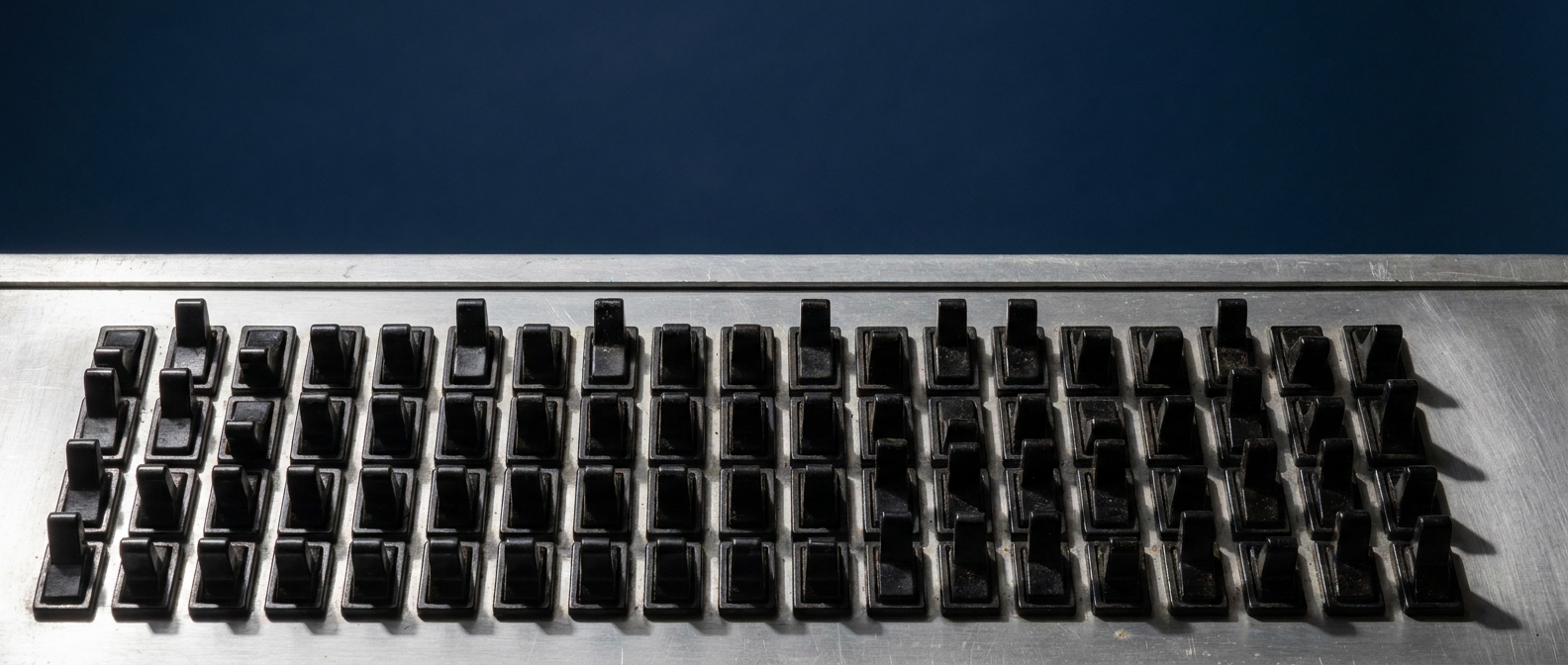 A bank of toggle switches in mixed states.