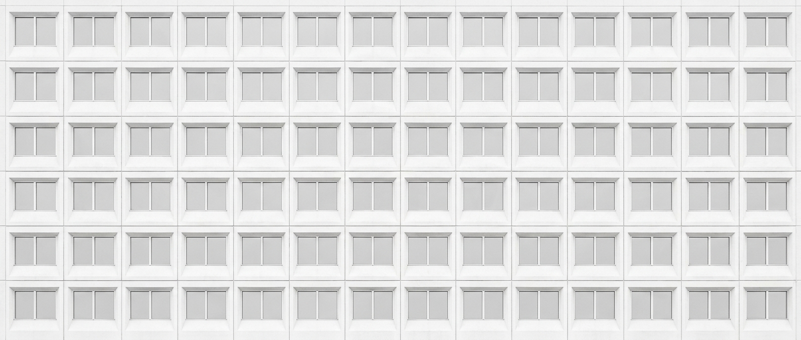 One office facade, flat and frontal, an unbroken grid of windows.