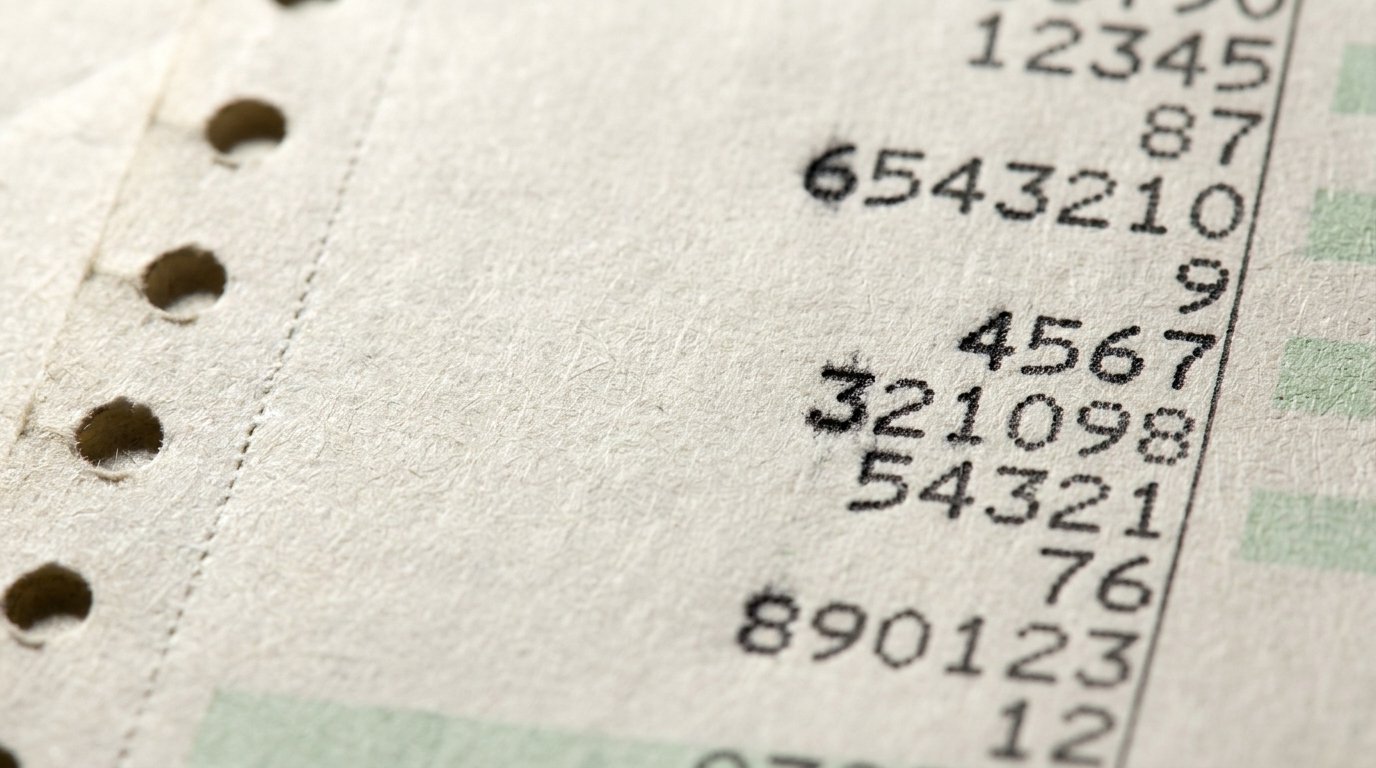 Extreme macro of impact-printed numerals in a ruled column on green-bar paper, each line a different value, the ink bled into the paper fibre.